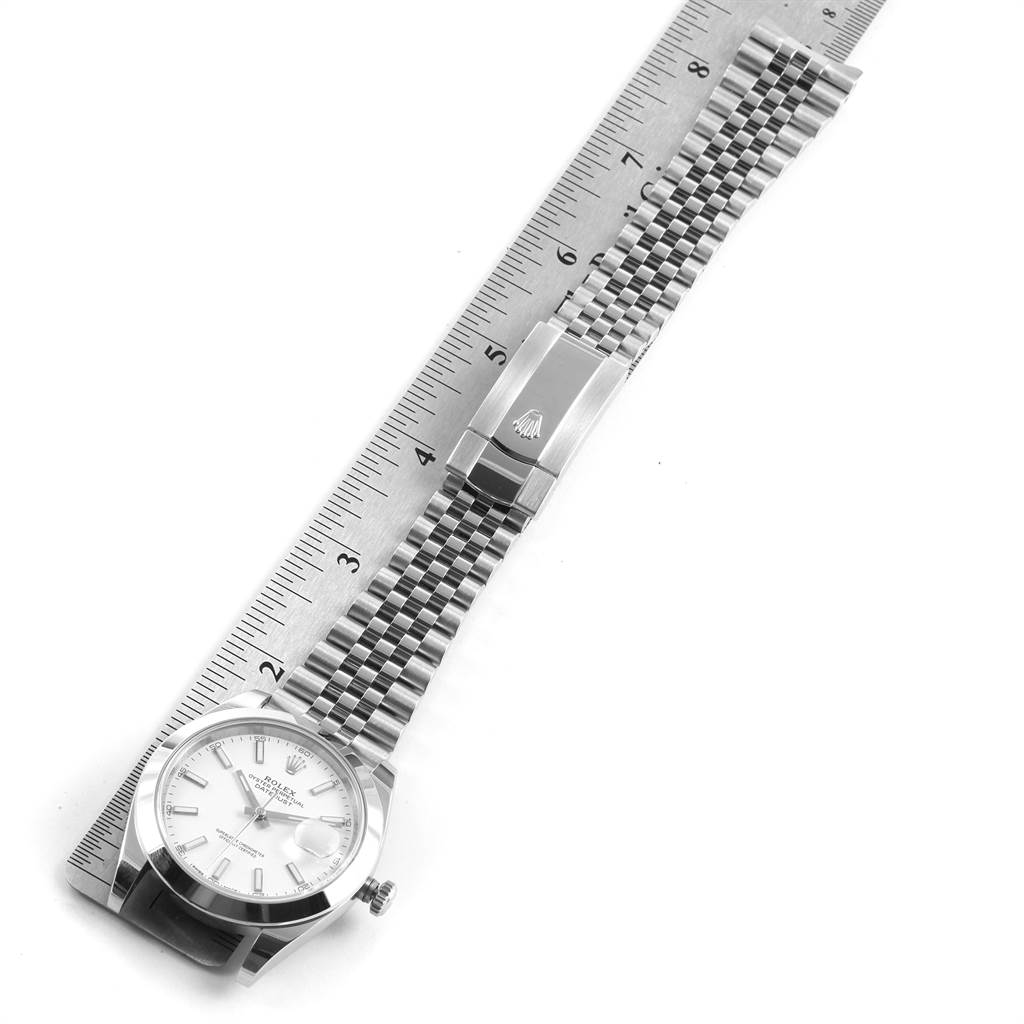 This image shows a Rolex Datejust 41 126300 Men's Stainless Steel White Dial 126300 Men's Stainless Steel White Dial watch laid flat next to a ruler, displaying the dial, crown, and bracelet with clasp.