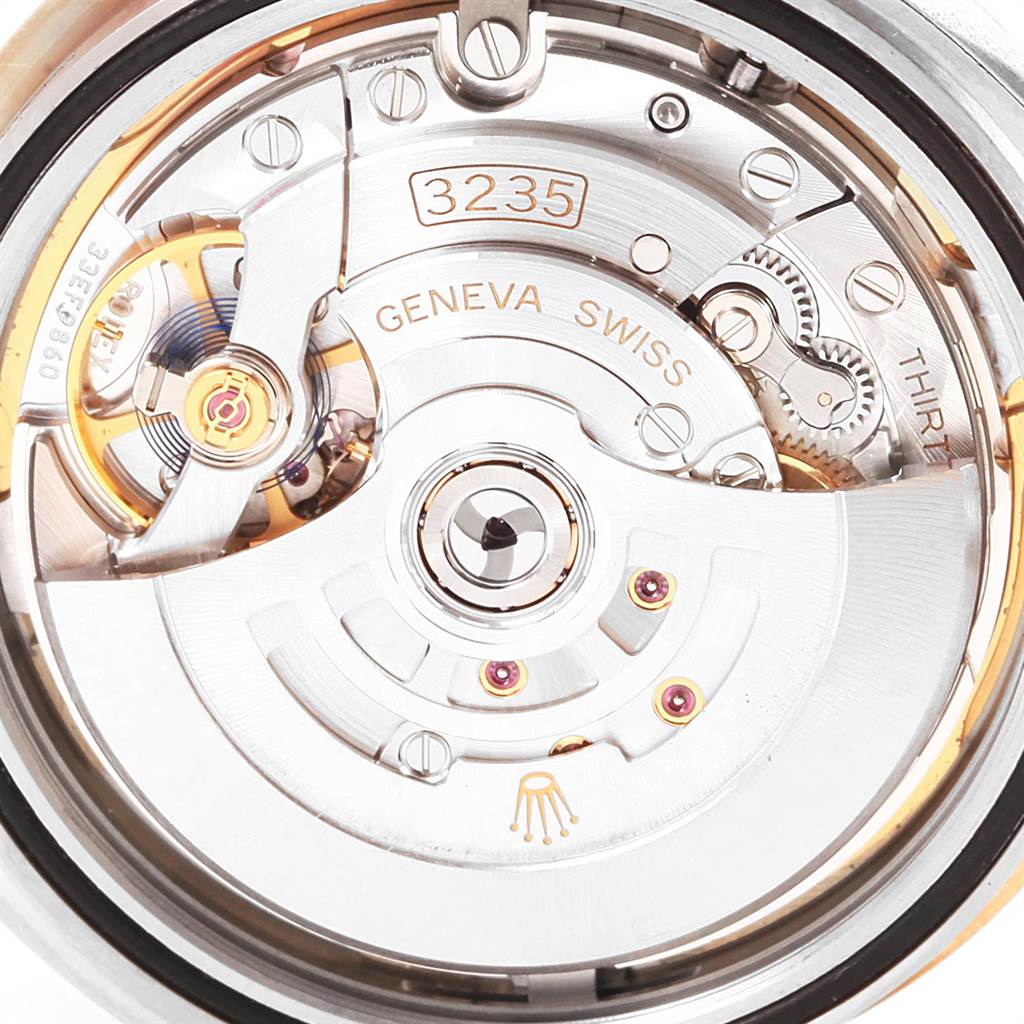 This image shows the internal movement of the Rolex Datejust 41 126333 Men's Steel and Gold (two tone) White Dial 126333 Men's Steel and Gold (two tone) White Dial, highlighting parts like the rotor and gears at a macro angle.