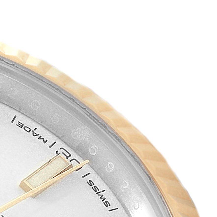 This close-up image of the Rolex Datejust 41 126333 Men's Steel and Gold (two tone) White Dial 126333 Men's Steel and Gold (two tone) White Dial shows the watch's dial, minute hand, and part of the fluted bezel.