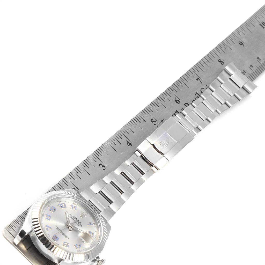 This image shows the Rolex Datejust 41 116334 Men's Stainless Steel Grey Dial 116334 Men's Stainless Steel Grey Dial watch laid flat, emphasizing its band and clasp, alongside a ruler for scale.