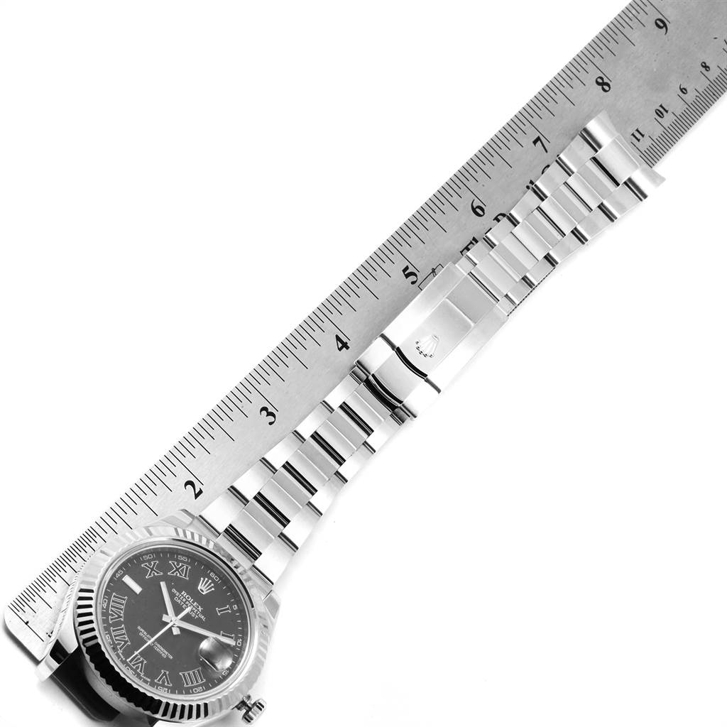 The image shows a top-down view of the Rolex Datejust 41 116334 Men's Stainless Steel Grey Dial 116334 Men's Stainless Steel Grey Dial watch, with a focus on its bracelet alongside a ruler.