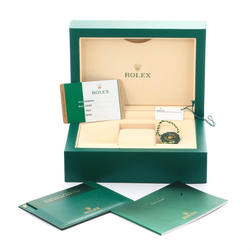 The image shows accessories for a Rolex Datejust 41 126300 Men's Stainless Steel White Dial 126300 Men's Stainless Steel White Dial, including the box, warranty card, tags, and booklets.