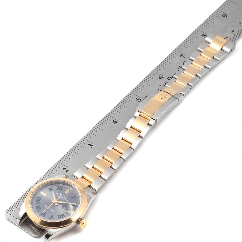 The Rolex Datejust 41 126303 Men's Steel and Gold (two tone) Grey Dial 126303 Men's Steel and Gold (two tone) Grey Dial model watch is shown from a top-down angle, displaying the face, bezel, and full bracelet length next to a ruler.