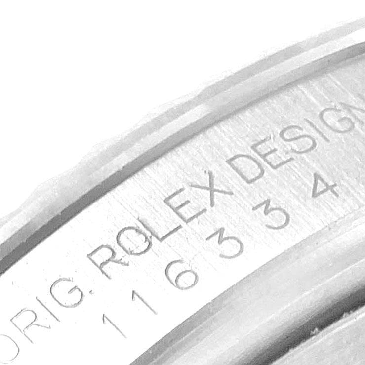 The image shows a close-up of the engraved bezel of a Rolex Datejust 41 116334 Men's Stainless Steel Black Dial 116334 Men's Stainless Steel Black Dial watch.