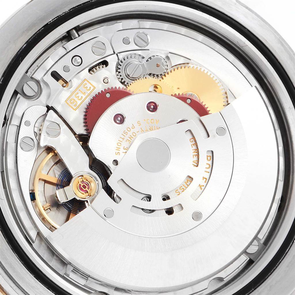 This image shows an inside view of the Rolex Datejust 41 116333 Men's Steel and Gold (two tone) Beige Dial 116333 Men's Steel and Gold (two tone) Beige Dial's movement mechanism, including gears and rotors.