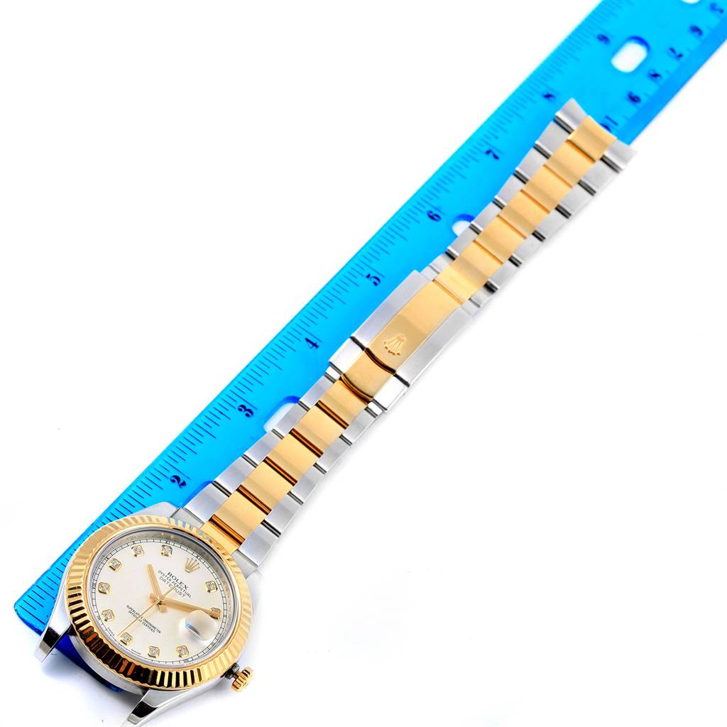 The Rolex Datejust 41 116333 Men's Steel and Gold (two tone) Beige Dial 116333 Men's Steel and Gold (two tone) Beige Dial watch is shown from a top-down angle, displaying its face, bezel, and full bracelet alongside a ruler for scale.