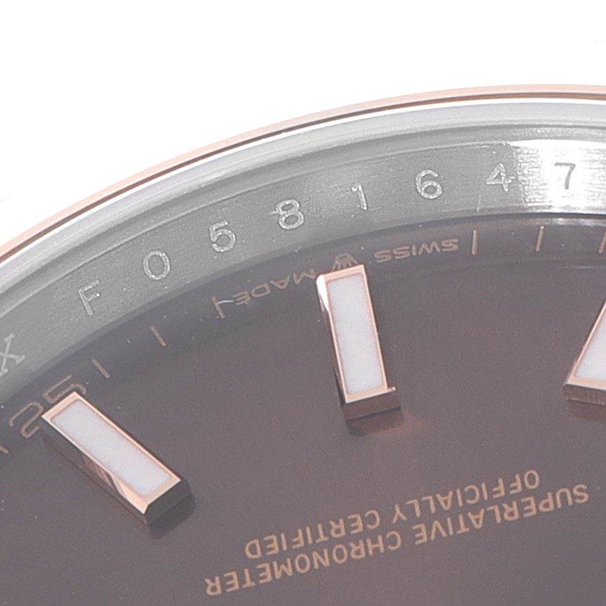 The image shows a close-up of the bezel and part of the face of a Rolex Datejust 41 126301 Men's Steel and Gold (two tone) Brown Dial 126301 Men's Steel and Gold (two tone) Brown Dial watch, displaying part of the serial number.