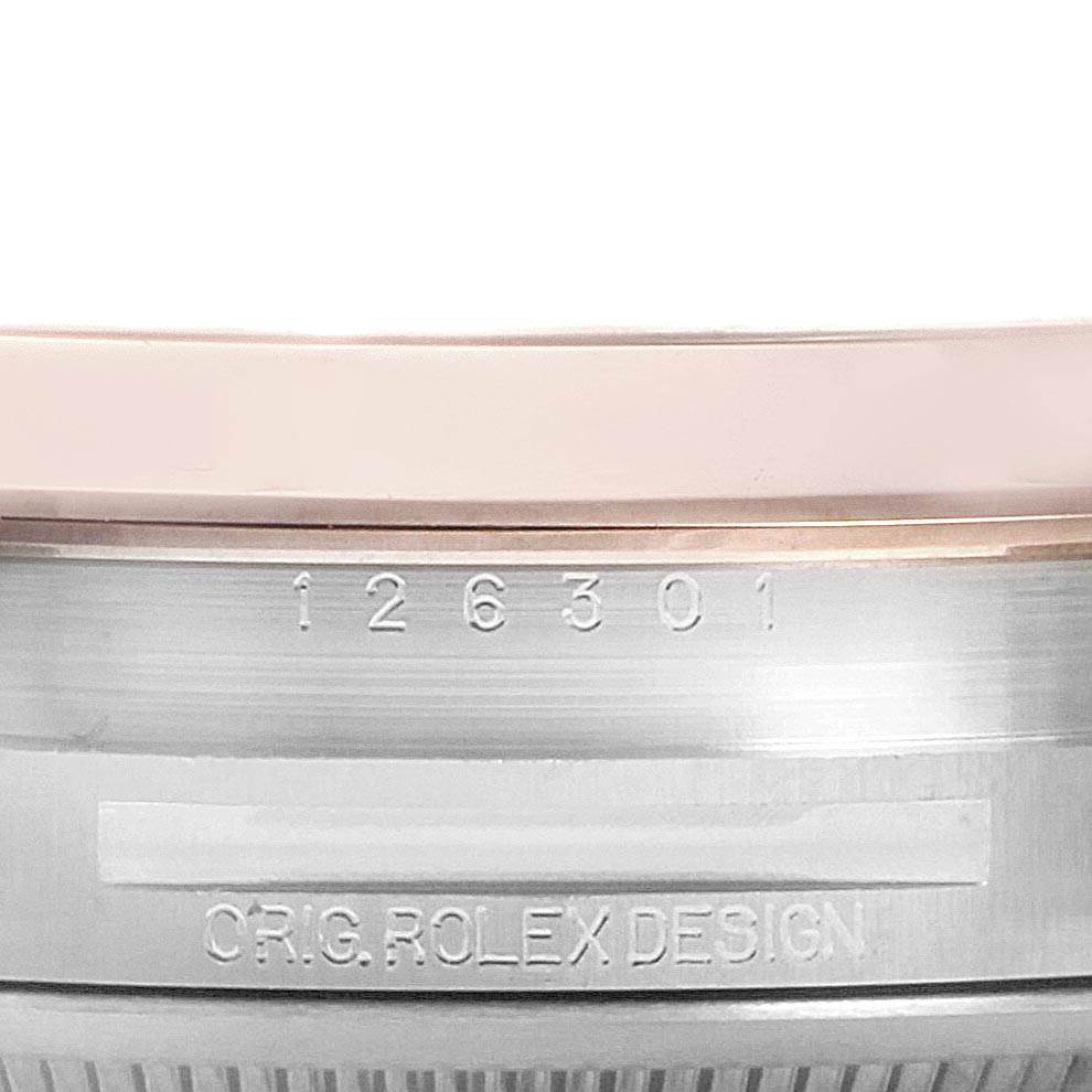 This close-up image shows the side of the bezel and case of a Rolex Datejust 41 126301 Men's Steel and Gold (two tone) Brown Dial 126301 Men's Steel and Gold (two tone) Brown Dial, displaying model engravings.