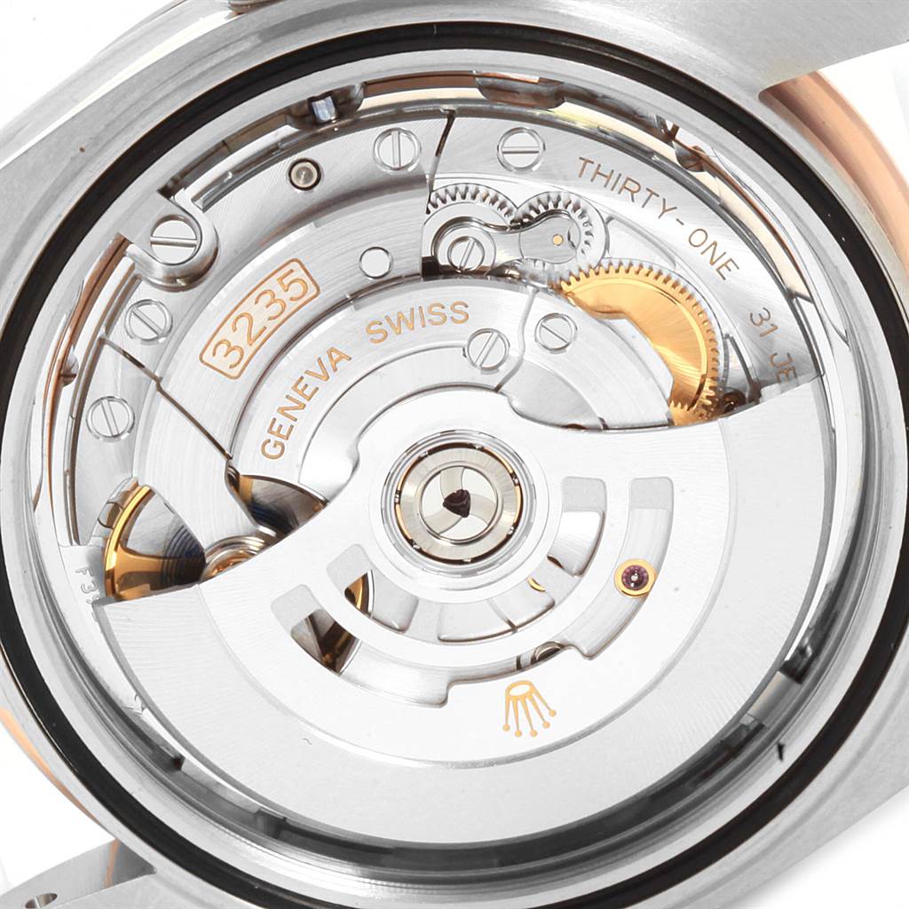 The image shows the inner mechanical workings of the Rolex Datejust 41 126301 Men
s Steel and Gold (two tone) Pink Dial 126301 Men
s Steel and Gold (two tone) Pink Dial model, including gears and the rotor engraved with "3235" and "ROLEX."