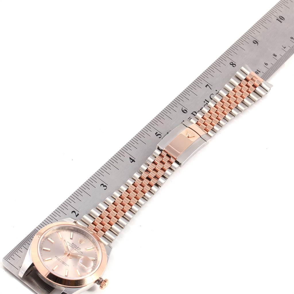 The image shows a Rolex Datejust 41 126301 Men
s Steel and Gold (two tone) Pink Dial 126301 Men
s Steel and Gold (two tone) Pink Dial watch, laid flat with its face and two-tone Jubilee bracelet aligned with a ruler.