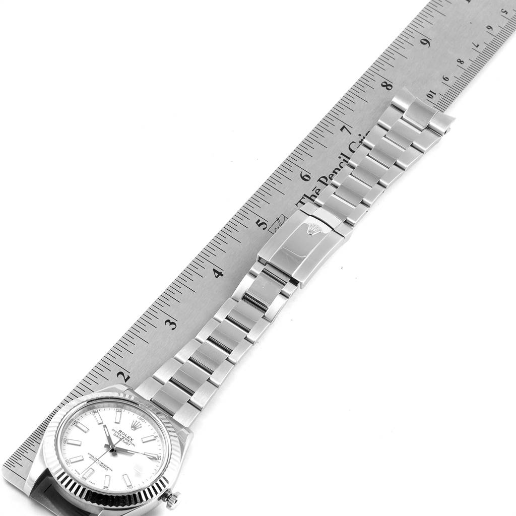 The image shows a top-down view of the Rolex Datejust 41 116334 Men's Stainless Steel White Dial 116334 Men's Stainless Steel White Dial watch, focusing on the dial, bracelet, and clasp next to a ruler.