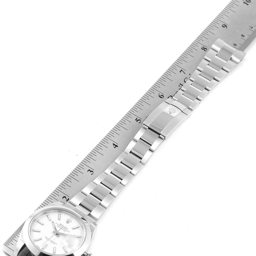 The image shows a Rolex Datejust 41 126300 Men's Stainless Steel White Dial 126300 Men's Stainless Steel White Dial watch laid flat next to a ruler, highlighting the bracelet and clasp.