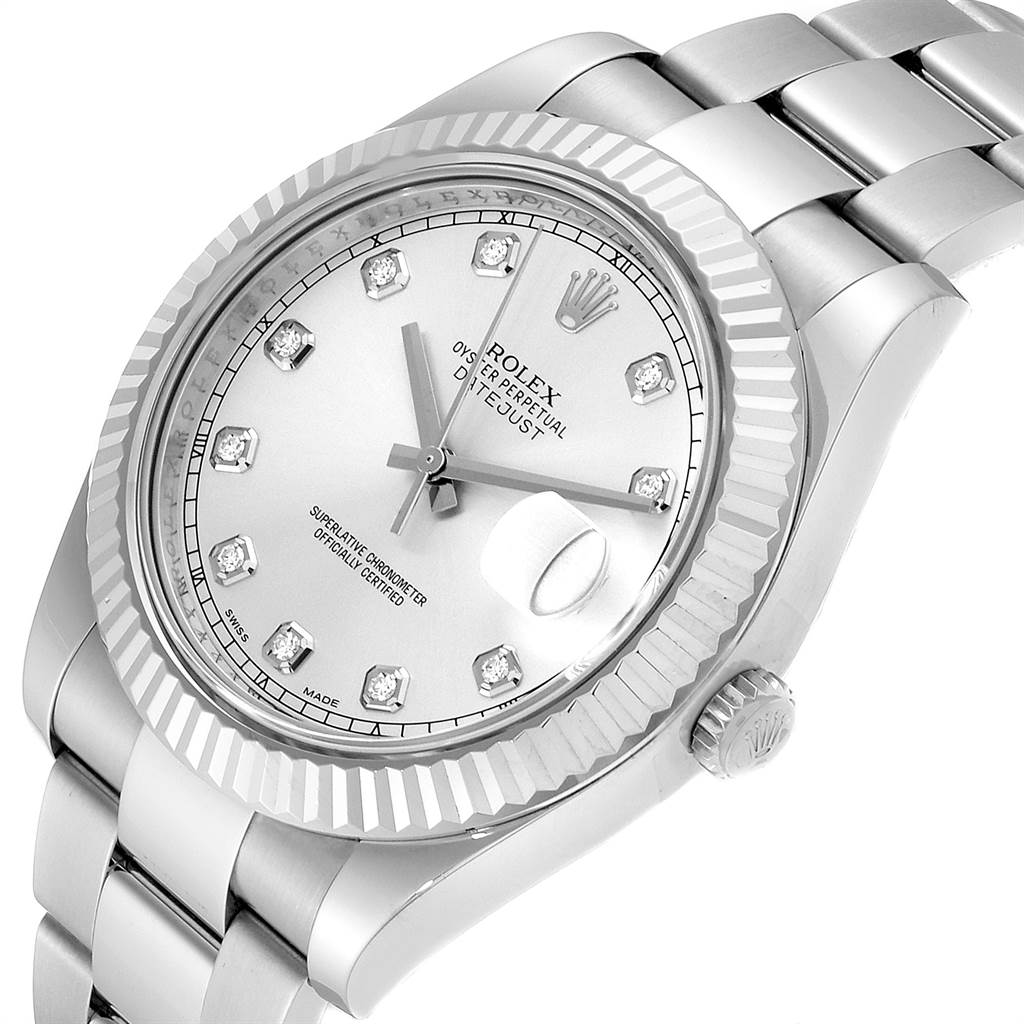 The image shows a tilted top view of a Rolex Datejust 41 116334 Men's Stainless Steel Silver Dial 116334 Men's Stainless Steel Silver Dial watch featuring its silver dial, diamond hour markers, fluted bezel, and Oyster bracelet.