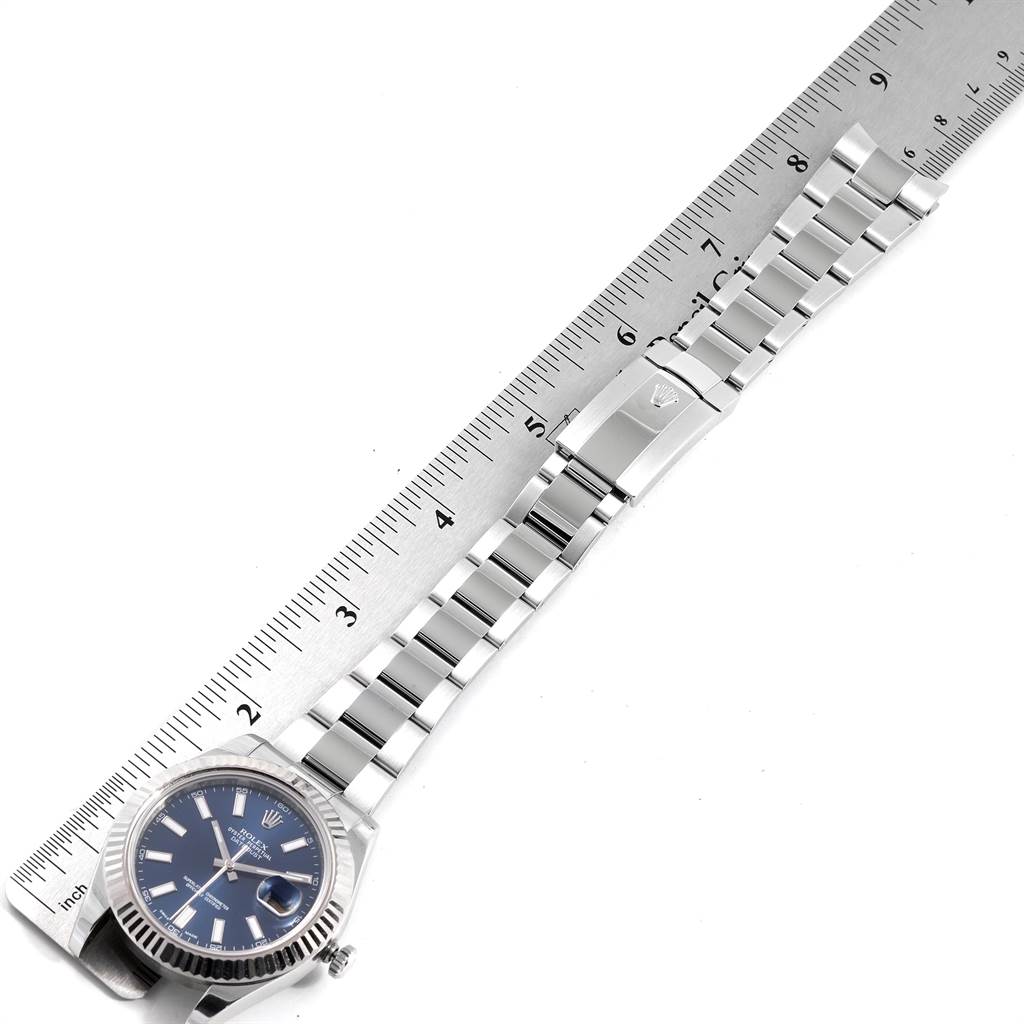 The Rolex Datejust 41 116334 Men's Stainless Steel Blue Dial 116334 Men's Stainless Steel Blue Dial is shown from the front, displaying its face, bracelet, and clasp, with a ruler for scale.