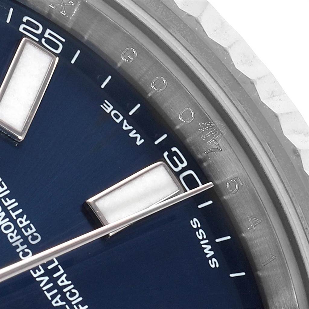 This close-up angle of the Rolex Datejust 41 116334 Men's Stainless Steel Blue Dial 116334 Men's Stainless Steel Blue Dial model shows part of the blue dial, minute marker, and fluted bezel.