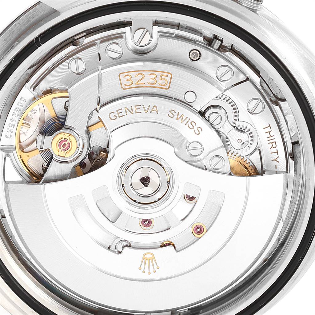 The image shows a close-up of the Rolex Datejust 41 126300 Men's Stainless Steel Grey Dial 126300 Men's Stainless Steel Grey Dial's movement, highlighting its intricate mechanisms and the "3235" marking.