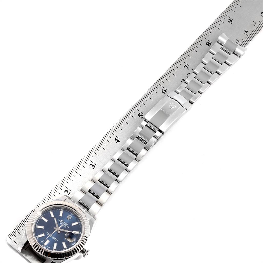 The image shows the Rolex Datejust 41 116334 Men's Stainless Steel Blue Dial 116334 Men's Stainless Steel Blue Dial watch and its metal bracelet alongside a ruler for measurement.