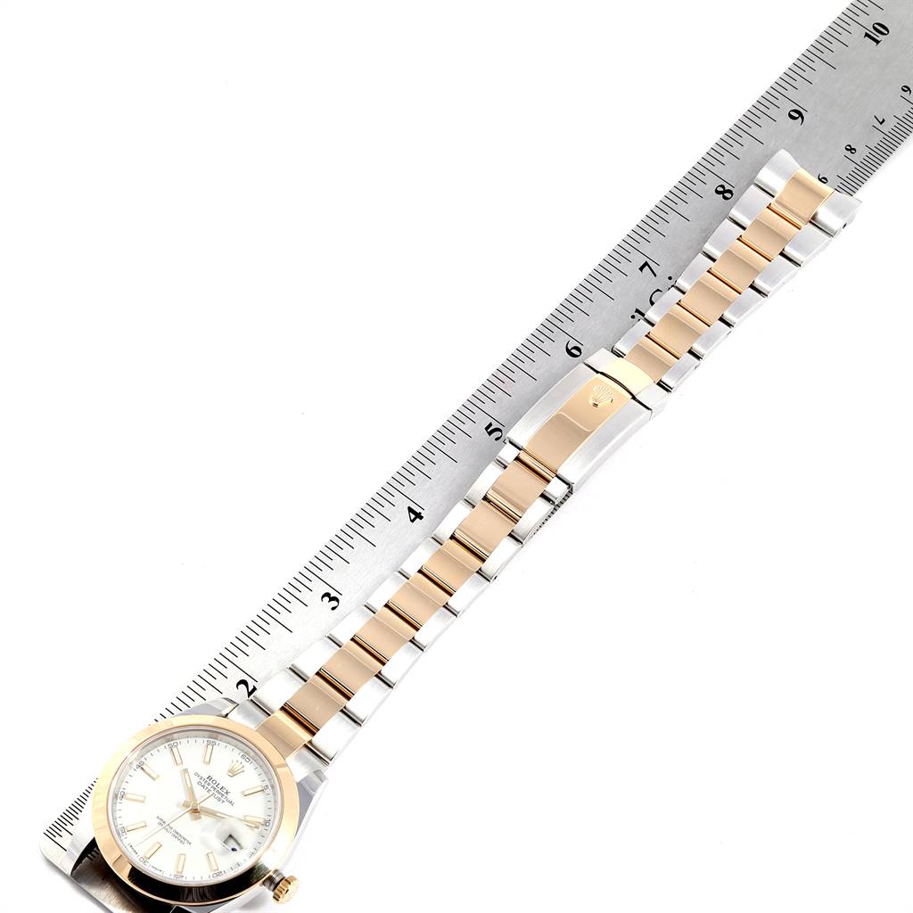 The Rolex Datejust 41 126303 Men's Steel and Gold (two tone) White Dial 126303 Men's Steel and Gold (two tone) White Dial watch is shown from an overhead angle, with the watch and a measuring ruler indicating the bracelet length.