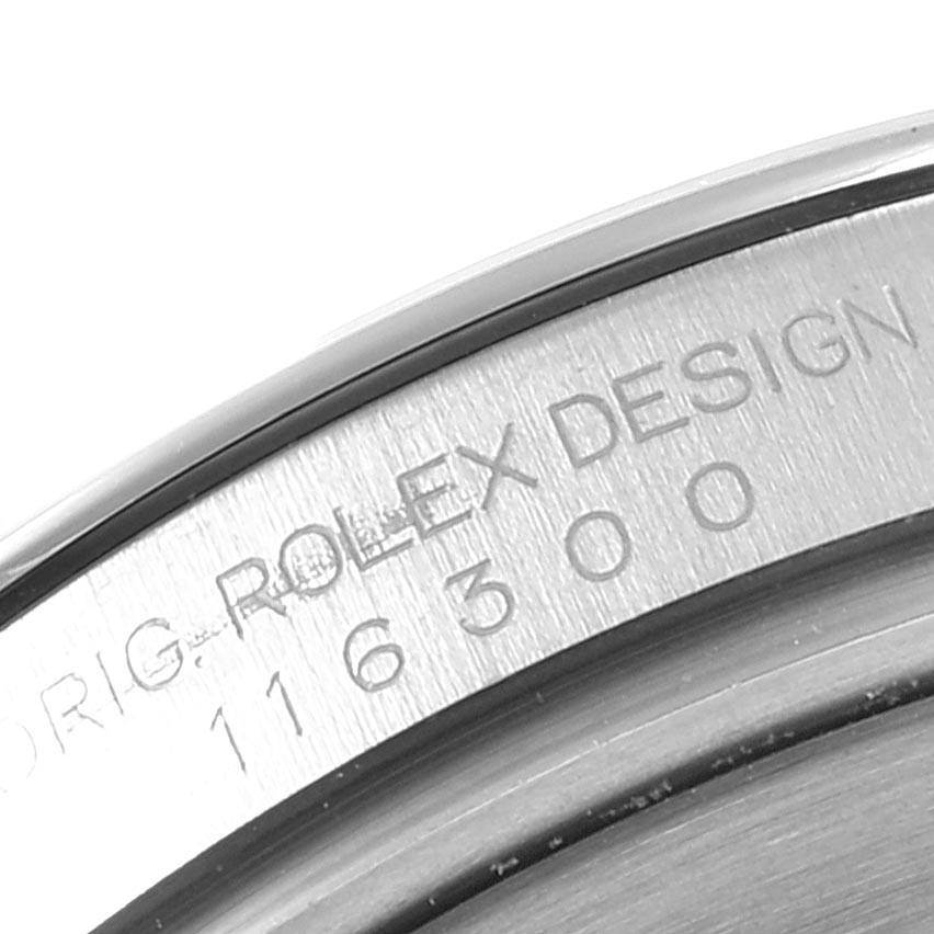 This close-up image of the Rolex Datejust 41 116300 Men's Stainless Steel Blue Dial 116300 Men's Stainless Steel Blue Dial shows a portion of the watch's case with engraved text.