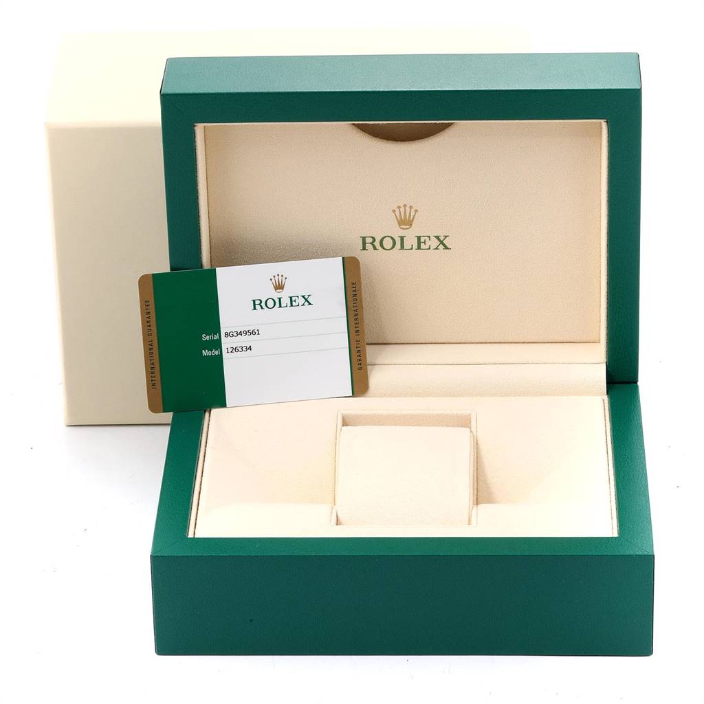 The image shows the open box of a Rolex Datejust 41 126334 Men's Stainless Steel Blue Dial 126334 Men's Stainless Steel Blue Dial with the warranty card displayed.