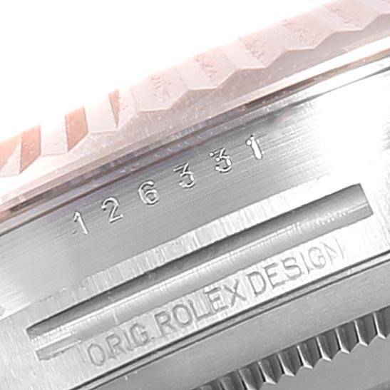 This image shows the model number and "ORIG. ROLEX DESIGN" engraving on the side of the bezel of a Rolex Datejust 41 126331 Men's Steel and Gold (two tone) Brown Dial 126331 Men's Steel and Gold (two tone) Brown Dial.