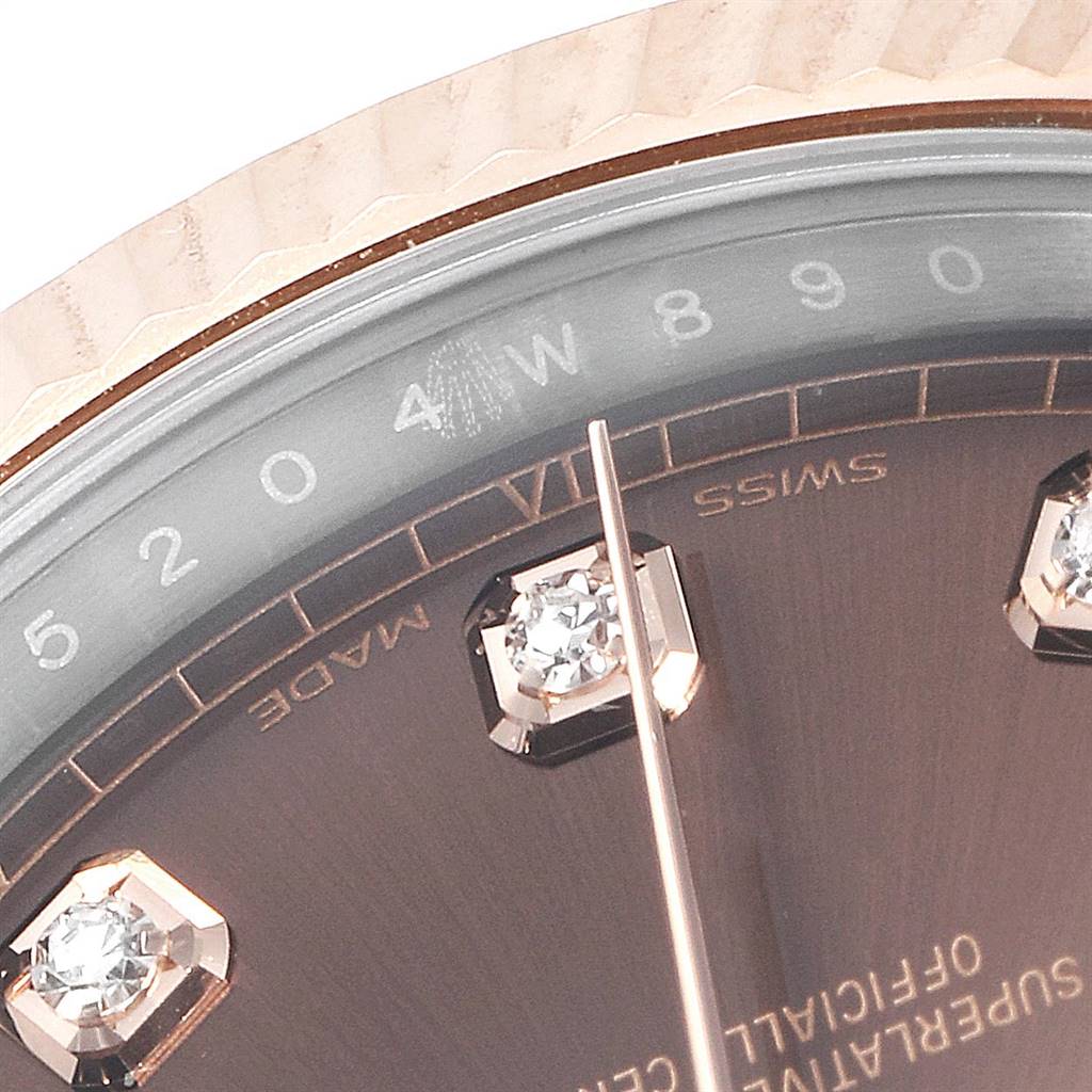 The image shows a close-up of the Rolex Datejust 41 126331 Men's Steel and Gold (two tone) Brown Dial 126331 Men's Steel and Gold (two tone) Brown Dial watch face, highlighting the diamond markers and the rehaut with serial engraving.