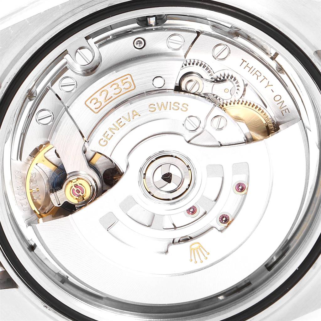 The image shows the intricate inner mechanism of the Rolex Datejust 41 126300 Men
s Stainless Steel Silver Dial 126300 Men
s Stainless Steel Silver Dial watch, including its movement parts and engravings.