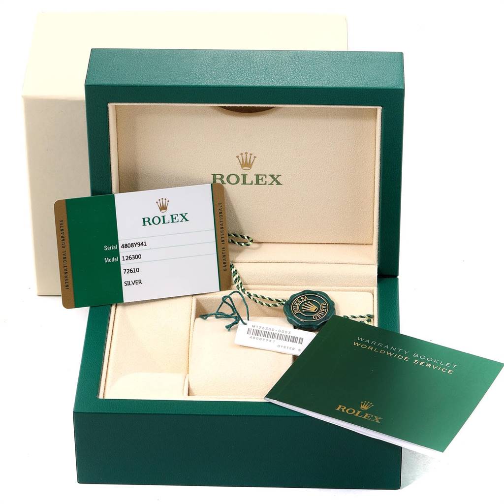 The image shows the packaging, warranty card, and tags for a Rolex Datejust 41 126300 Men
s Stainless Steel Silver Dial 126300 Men
s Stainless Steel Silver Dial model.