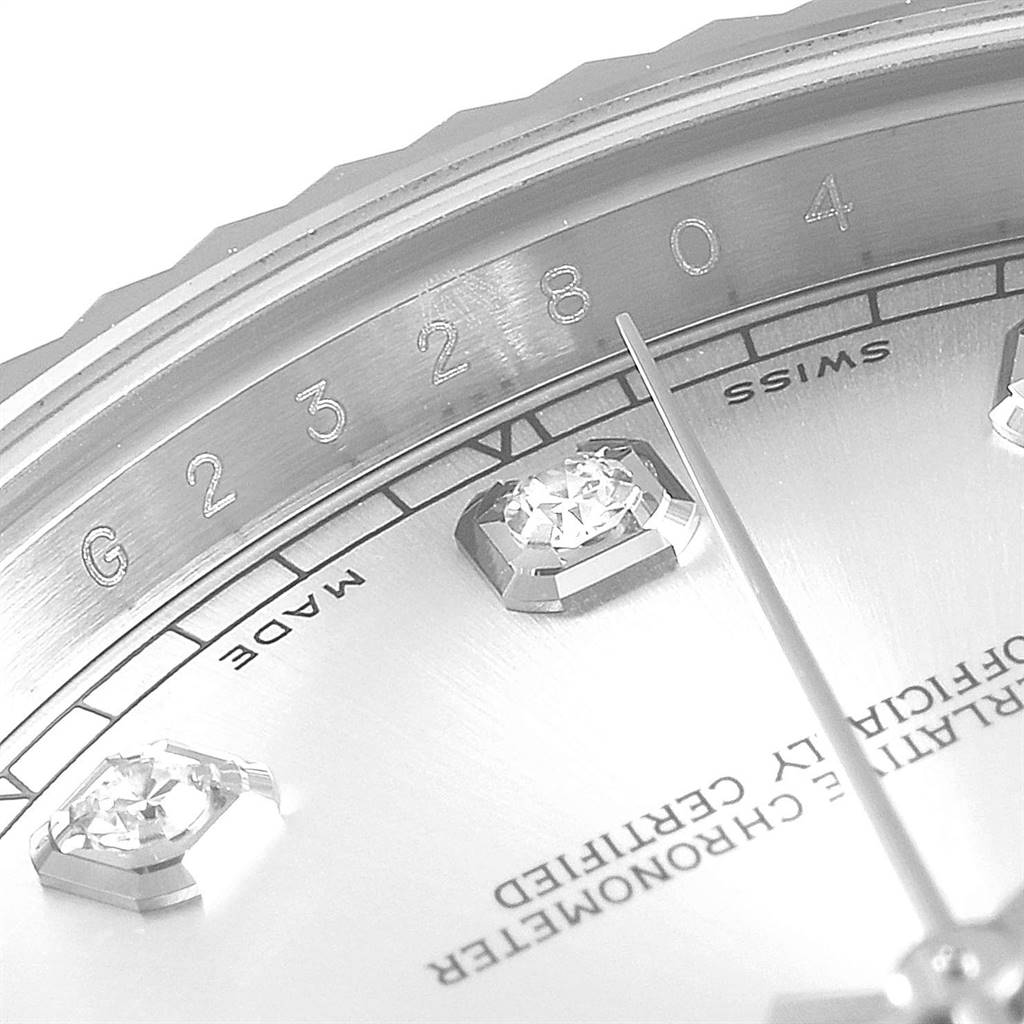 This close-up image of the Rolex Datejust 41 116334 Men's Stainless Steel Silver Dial 116334 Men's Stainless Steel Silver Dial watch shows part of the dial, a diamond hour marker, and the serial number on the rehaut.