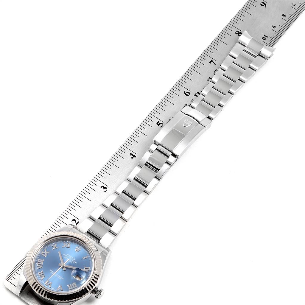 The image shows a Rolex Datejust 41 116334 Men's Stainless Steel Blue Dial 116334 Men's Stainless Steel Blue Dial watch laid flat next to a ruler, highlighting its bracelet and clasp.