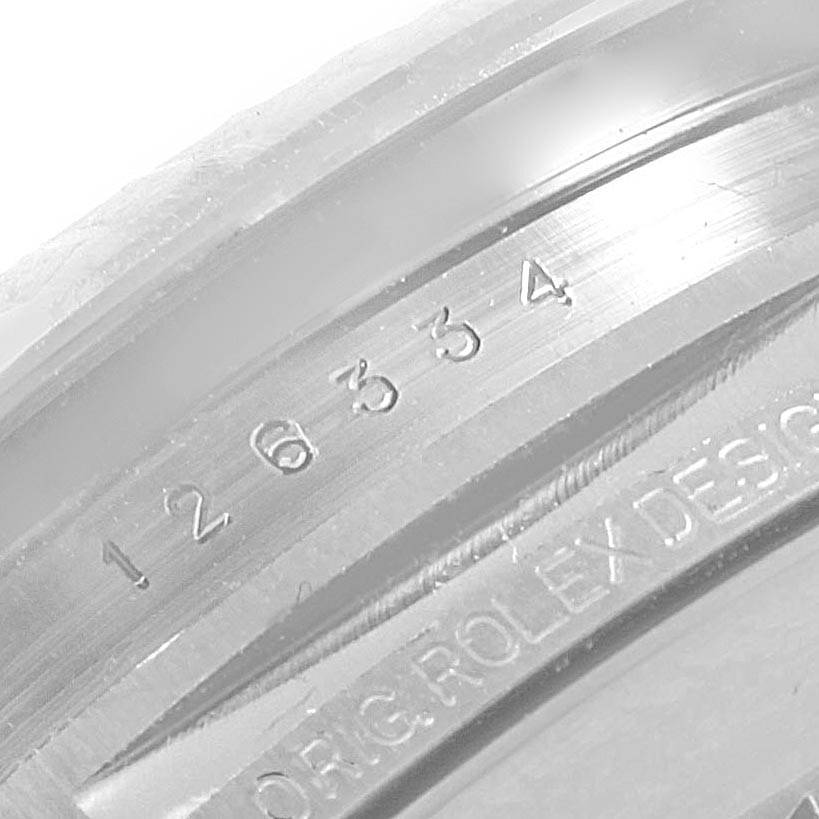 This close-up image shows the inner bezel of a Rolex Datejust 41 126334 Men's Stainless Steel White Dial 126334 Men's Stainless Steel White Dial, displaying its engraved serial number and "ORIG ROLEX DESIGN".