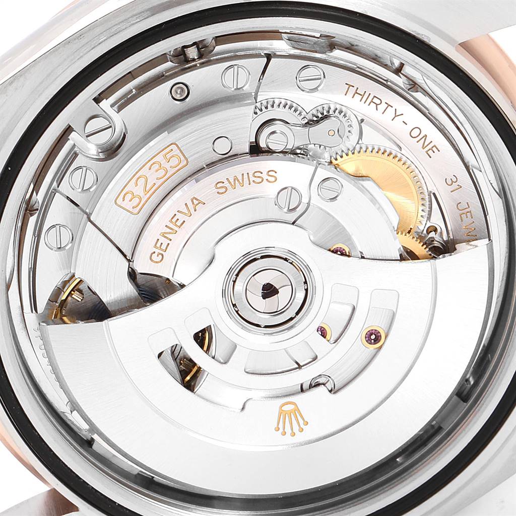 The image shows the movement and inner mechanism of the Rolex Datejust 41 126301 Men's Steel and Gold (two tone) Pink Dial 126301 Men's Steel and Gold (two tone) Pink Dial watch, including the rotor and gears.