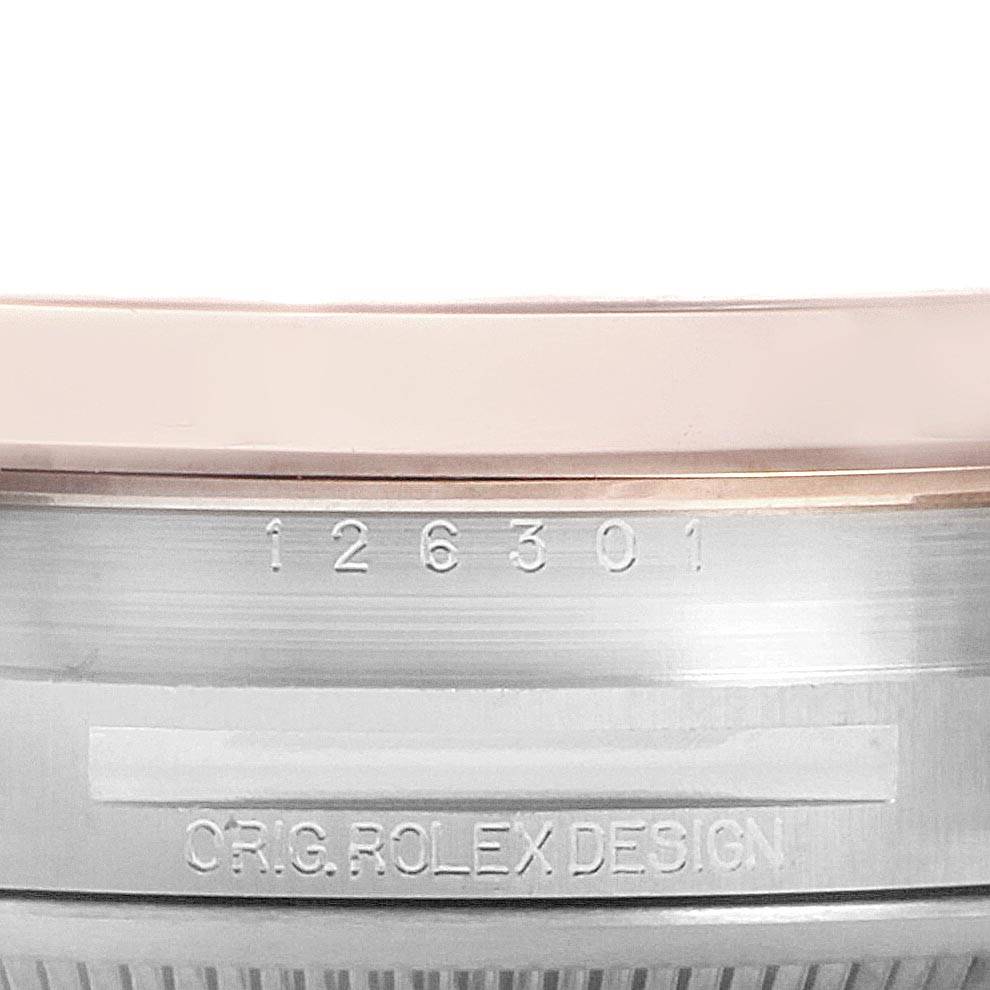 The image shows a close-up of the side of a Rolex Datejust 41 126301 Men's Steel and Gold (two tone) Pink Dial 126301 Men's Steel and Gold (two tone) Pink Dial watch, revealing the model number and "ORIG ROLEX DESIGN" engraving.