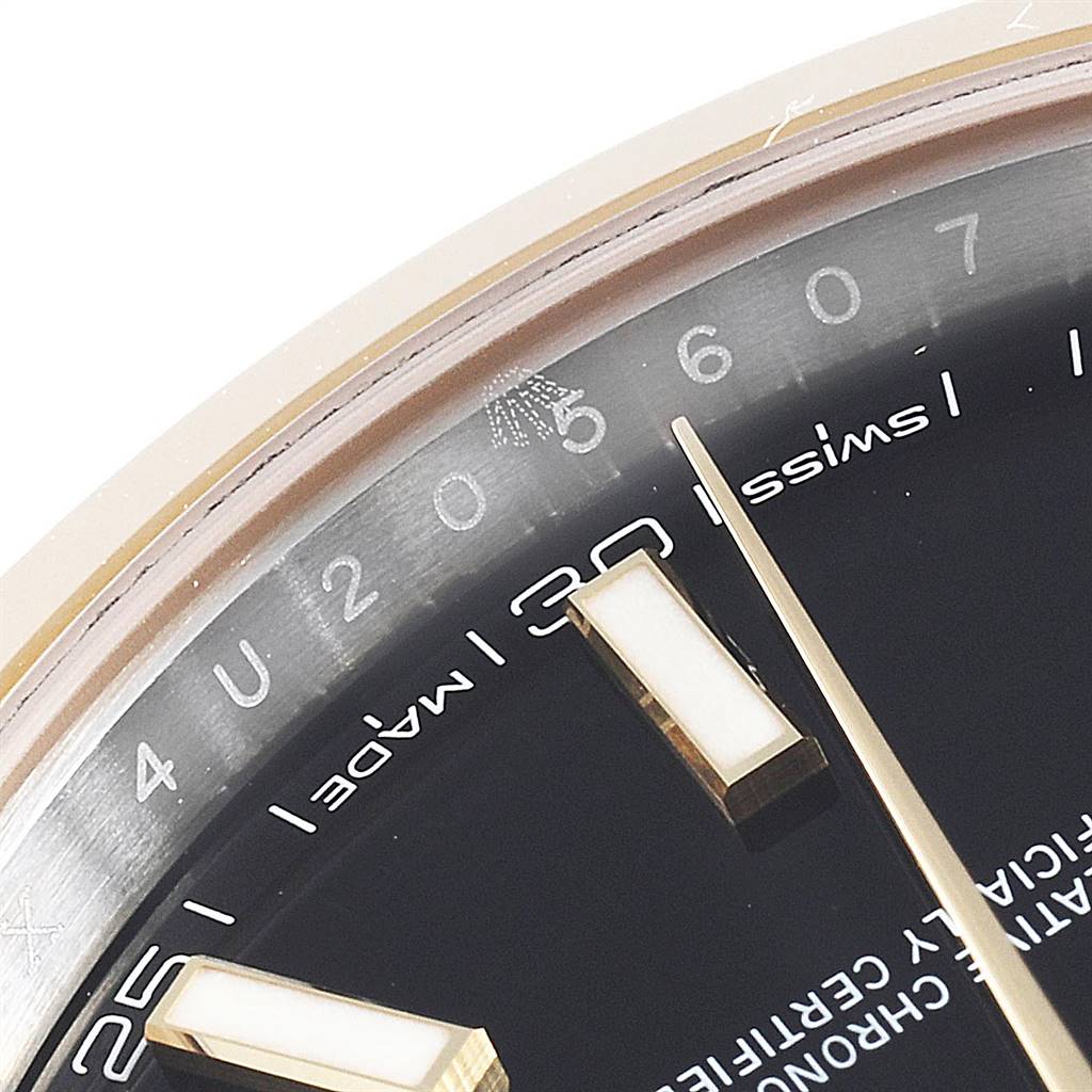 This close-up of a Rolex Datejust 41 126303 Men's Steel and Gold (two tone) Black Dial 126303 Men's Steel and Gold (two tone) Black Dial watch highlights the dial, hour markers, and part of the minute hand.