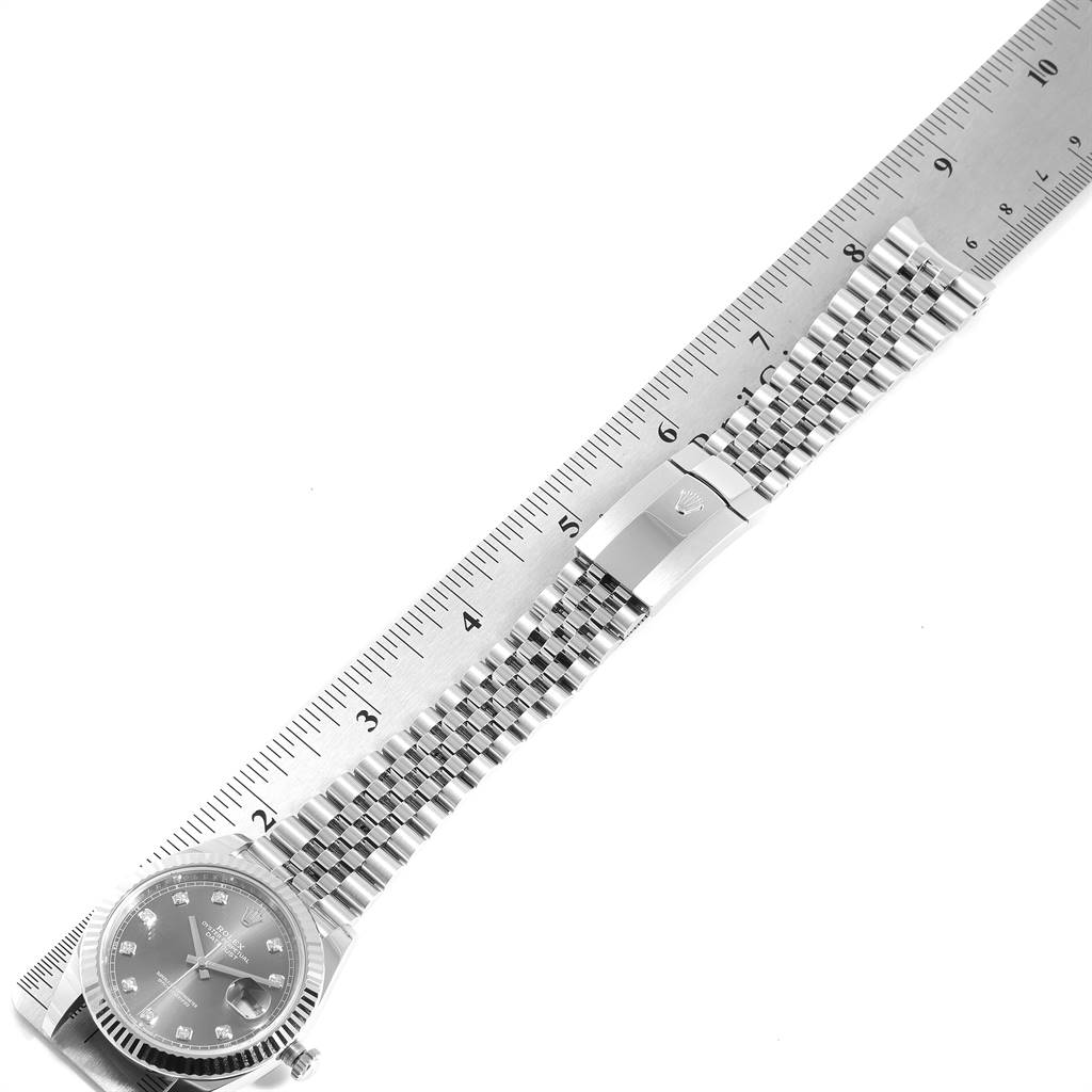 The image shows the Rolex Datejust 41 126334 Men's Stainless Steel Grey Dial 126334 Men's Stainless Steel Grey Dial watch laid flat, with a focus on its face and bracelet measured against a ruler.