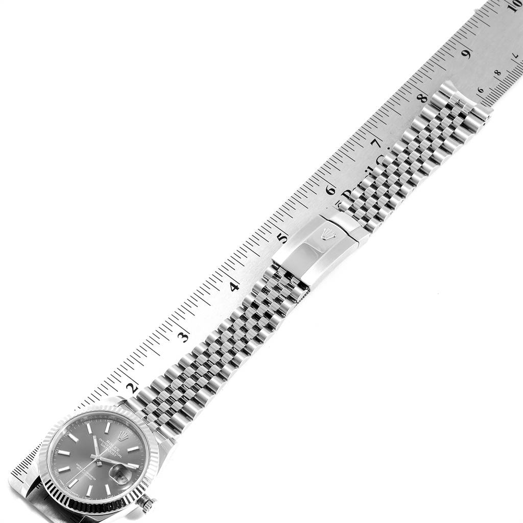 This image shows a top view of a Rolex Datejust 41 126334 Men's Stainless Steel Grey Dial 126334 Men's Stainless Steel Grey Dial watch with its full bracelet alongside a ruler for size reference.