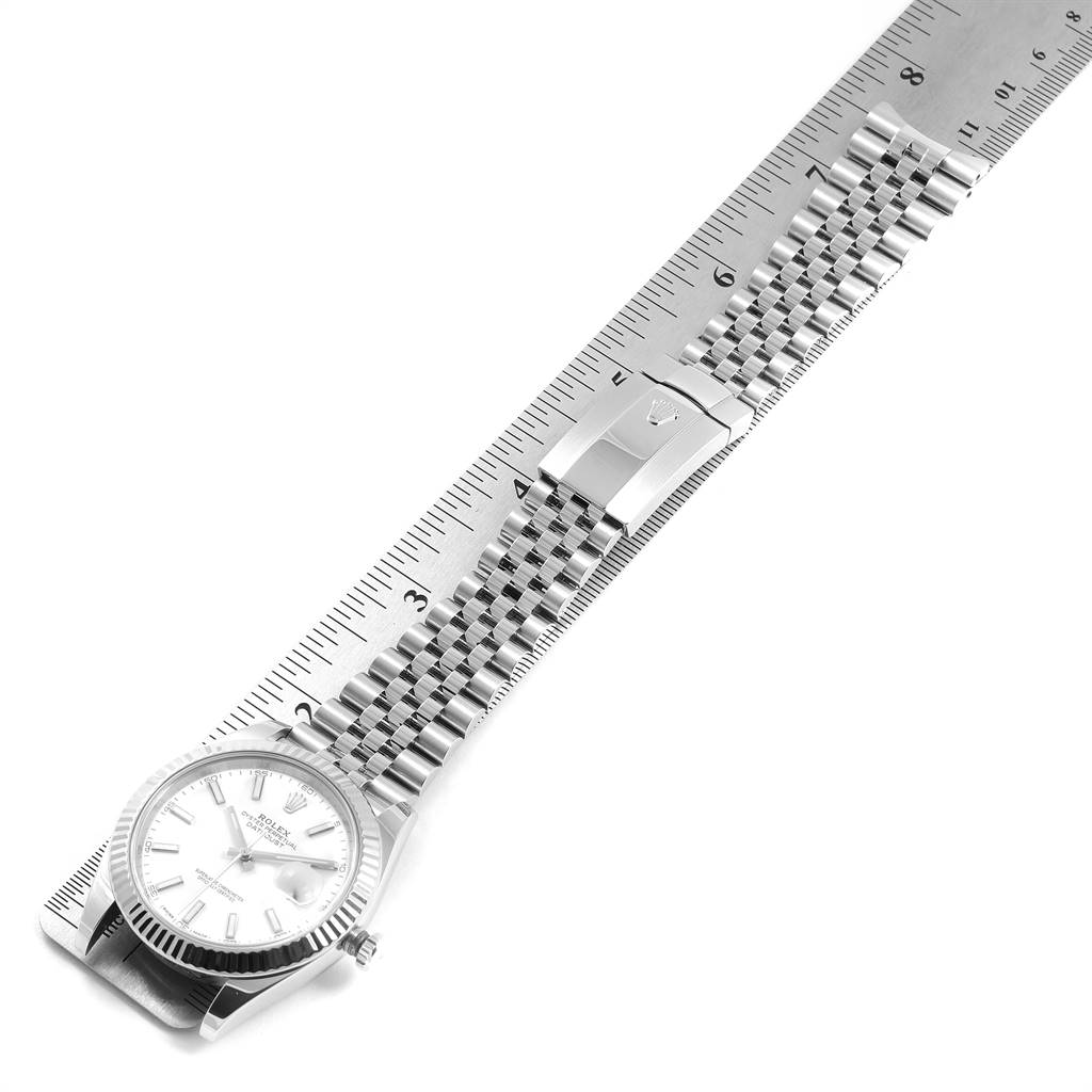 The image shows a Rolex Datejust 41 126334 Men's Stainless Steel White Dial 126334 Men's Stainless Steel White Dial watch laid flat with its stainless steel Jubilee bracelet extended along a ruler.