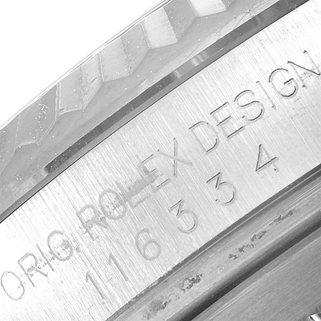 This image shows a close-up of the engraved case edge of a Rolex Datejust 41 116334 Men's Stainless Steel Silver Dial 116334 Men's Stainless Steel Silver Dial watch, focusing on the text "ORIG. ROLEX DESIGN."