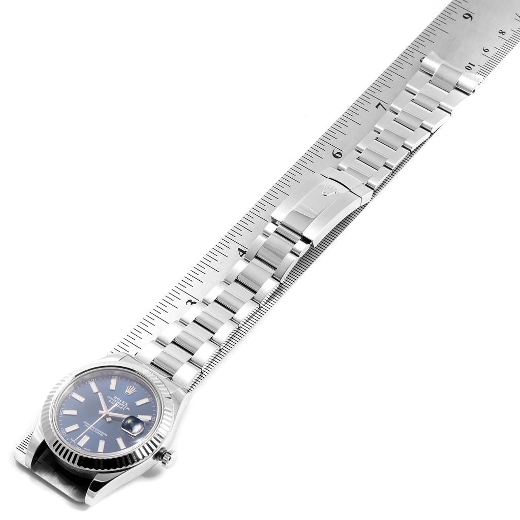 The image shows the Rolex Datejust 41 116334 Men's Stainless Steel Blue Dial 116334 Men's Stainless Steel Blue Dial watch positioned diagonally, with its bracelet measured against a ruler.