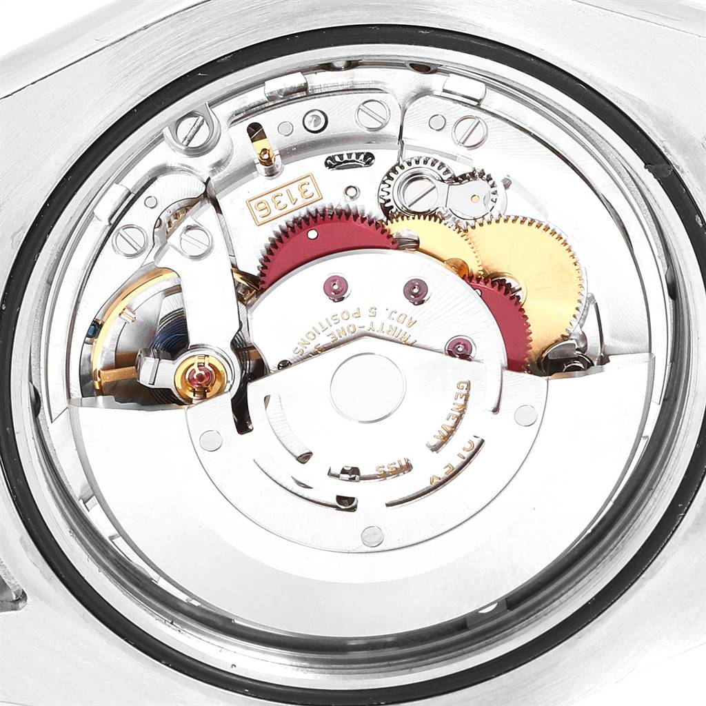 The image shows the internal mechanism of a Rolex Datejust 41 116334 Men
s Stainless Steel Blue Dial 116334 Men
s Stainless Steel Blue Dial watch from a close-up angle, highlighting its intricate gears and components.