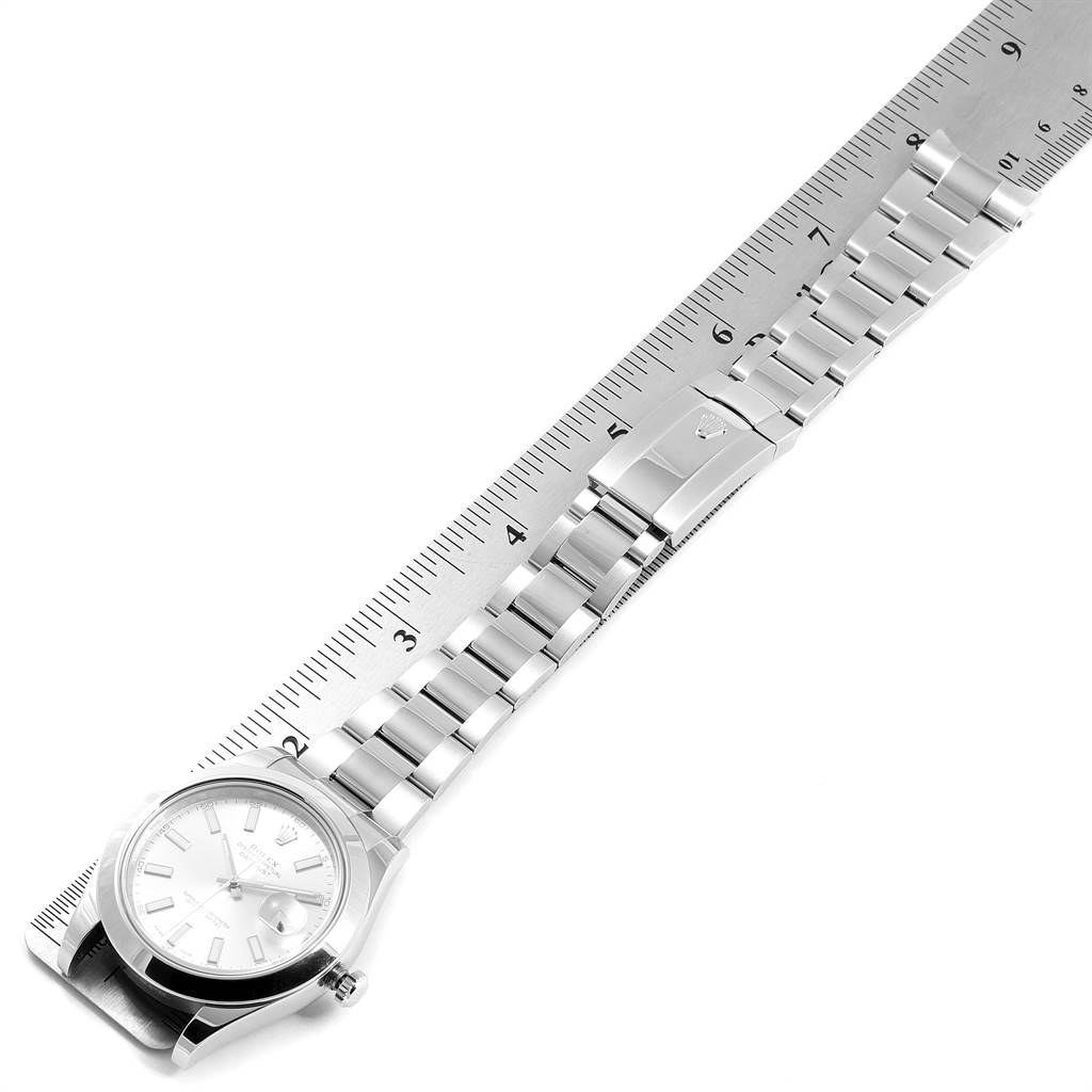 The image shows a Rolex Datejust 41 116300 Men's Stainless Steel Silver Dial 116300 Men's Stainless Steel Silver Dial watch laid flat next to a ruler, displaying its face and entire stainless steel bracelet.