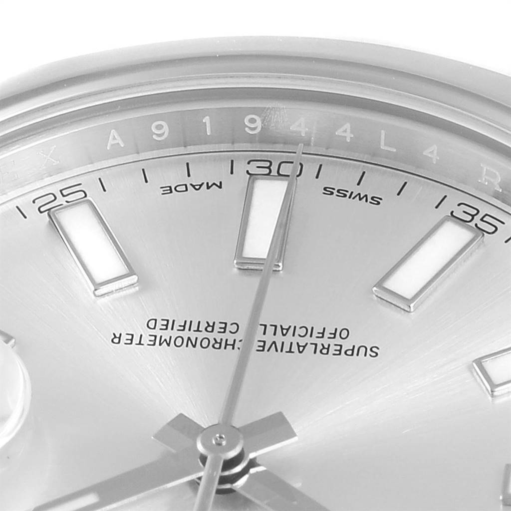 This image shows a close-up of the Rolex Datejust 41 116300 Men's Stainless Steel Silver Dial 116300 Men's Stainless Steel Silver Dial watch face, featuring hour markers, text details, and part of the hands.