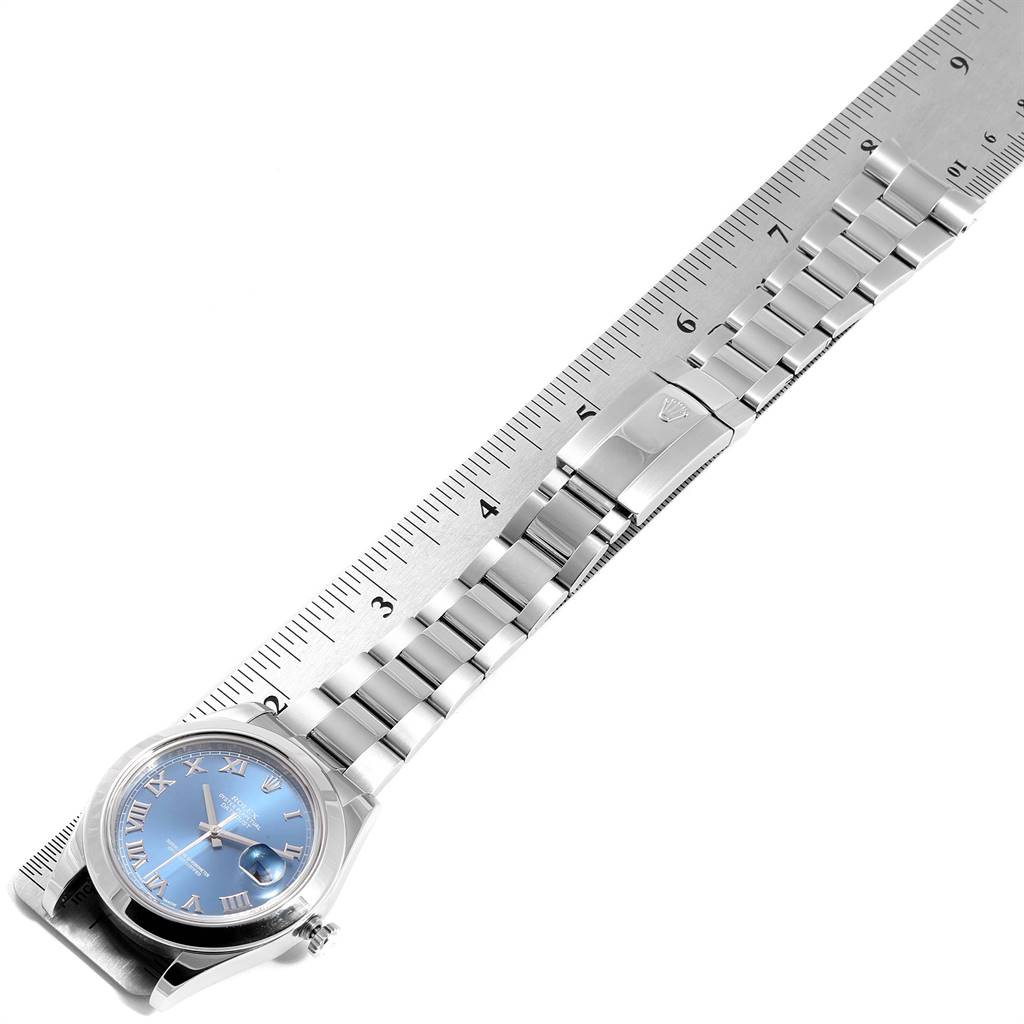 The Rolex Datejust 41 116300 Men's Stainless Steel Blue Dial 116300 Men's Stainless Steel Blue Dial watch is shown from an overhead angle, featuring the dial, bracelet, and clasp aligned with a ruler.