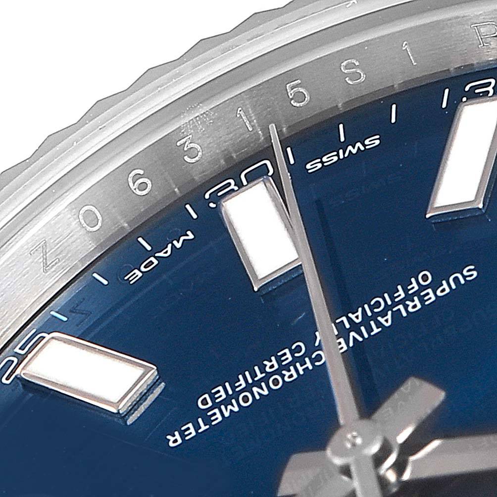 This close-up image of the Rolex Datejust 41 116334 Men's Stainless Steel Blue Dial 116334 Men's Stainless Steel Blue Dial watch displays the bezel, hour markers, and part of the minute hand.