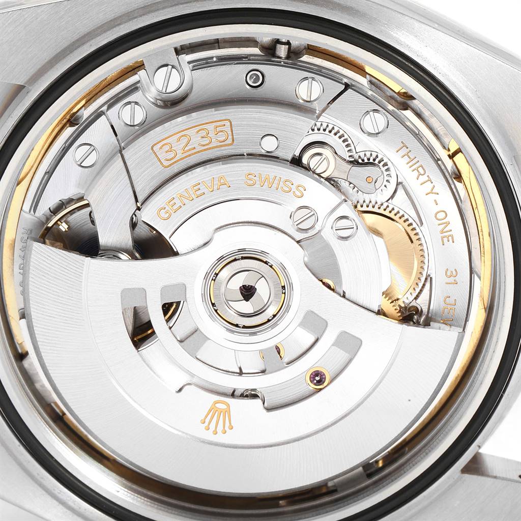 This is a close-up view of the Rolex Datejust 41 126334 Men's Stainless Steel Black Dial 126334 Men's Stainless Steel Black Dial's movement, showing gears, jewels, and the rotor with "3235" and "Geneva Swiss" engravings.