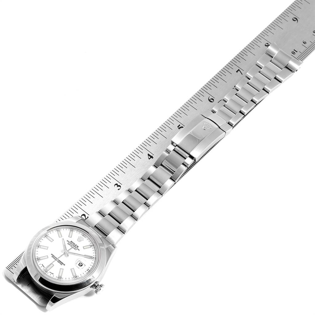 This image shows a Rolex Datejust 41 116300 Men's Stainless Steel White Dial 116300 Men's Stainless Steel White Dial watch laid flat with the case and full stainless steel bracelet visible, next to a ruler for scale.