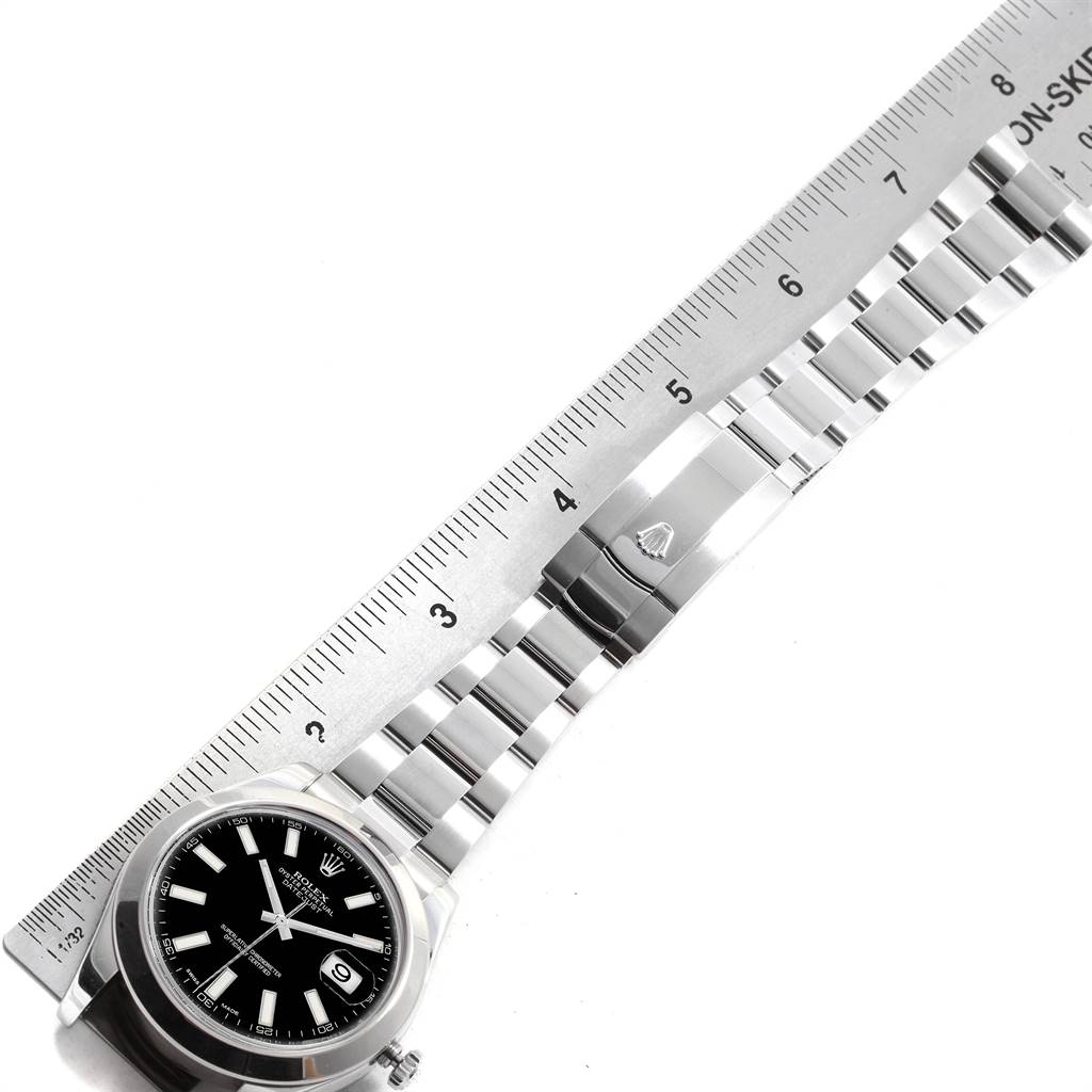 The image shows a top-down view of a Rolex Datejust 41 116300 Men's Stainless Steel Black Dial 116300 Men's Stainless Steel Black Dial watch and part of its bracelet alongside a ruler for size reference.