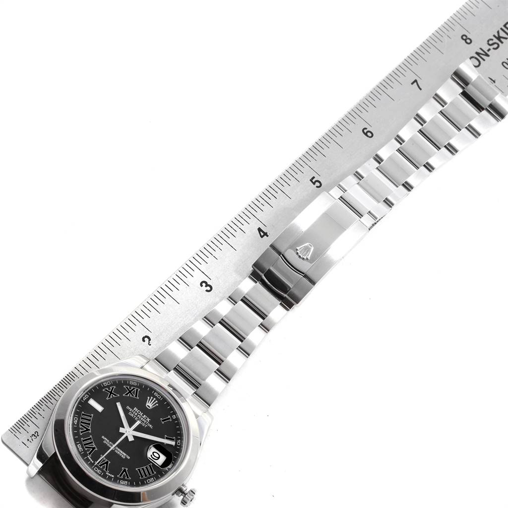 The image shows a top-down view of a Rolex Datejust 41 116300 Men's Stainless Steel Grey Dial 116300 Men's Stainless Steel Grey Dial model, featuring the watch face, bracelet, and clasp next to a ruler.