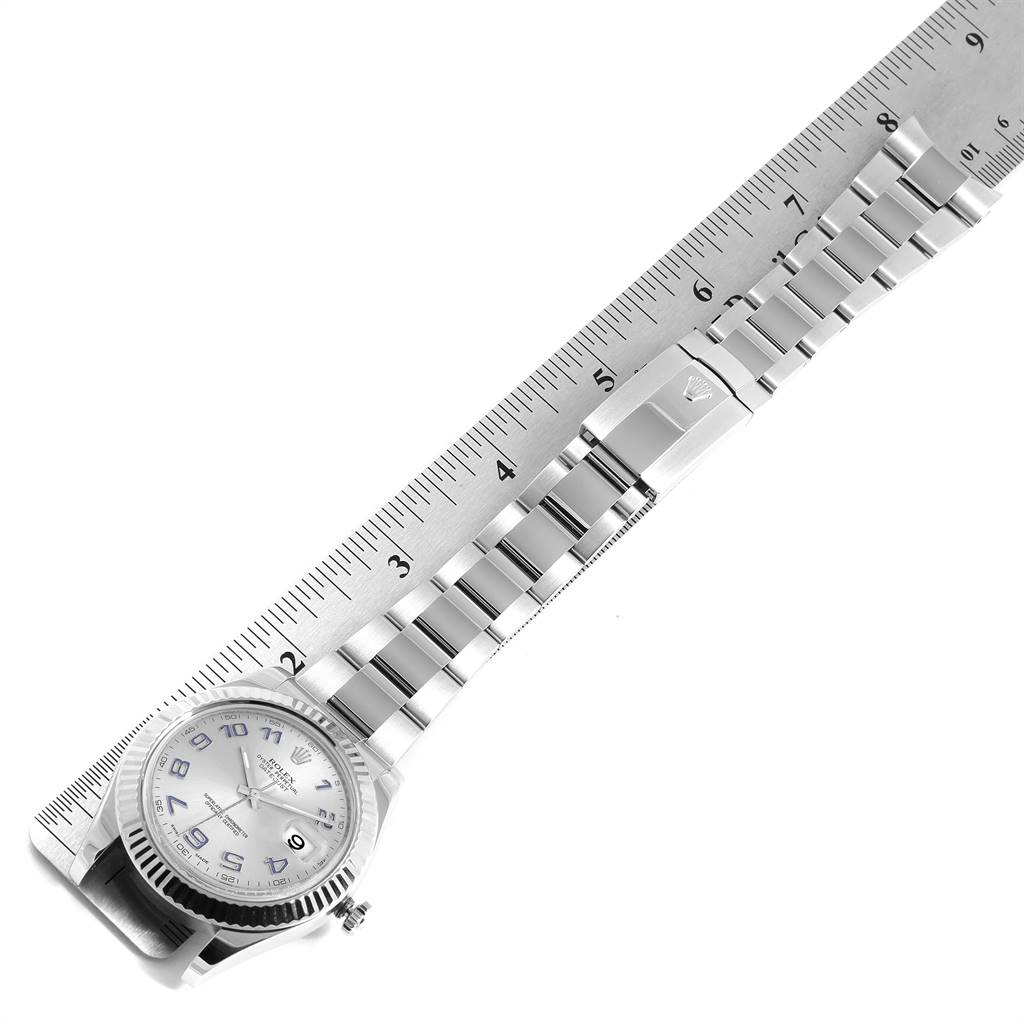 The Rolex Datejust 41 116334 Men's Stainless Steel Silver Dial 116334 Men's Stainless Steel Silver Dial watch is shown from above, with a metal strap laid out and a ruler measuring its length.