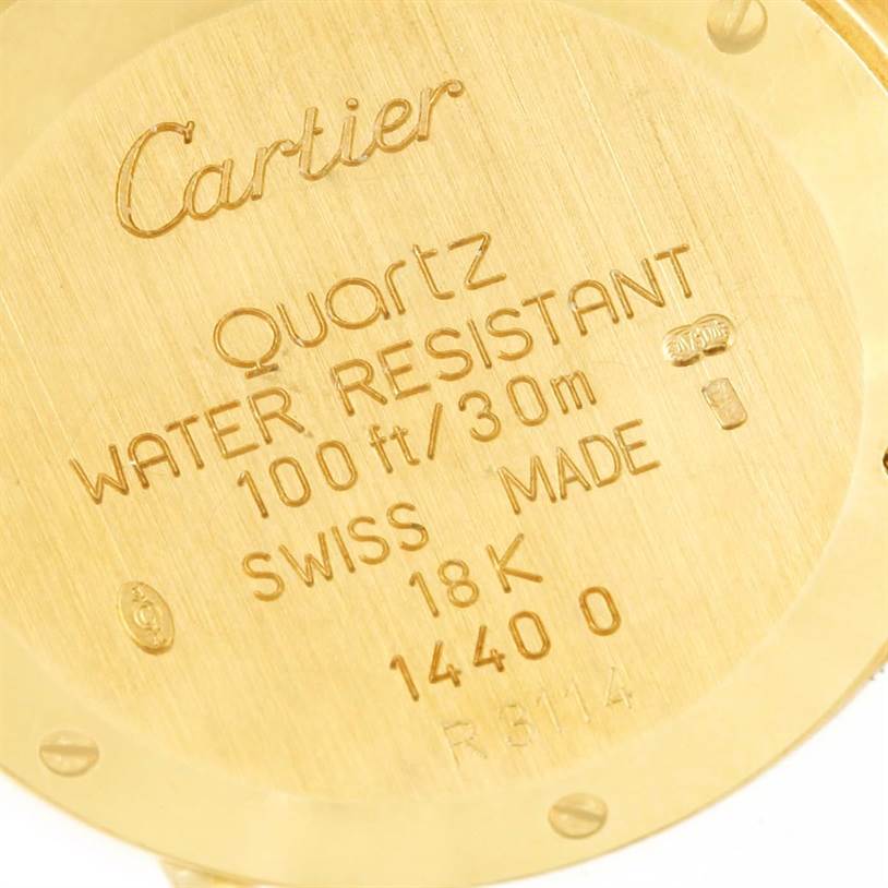 Close-up of the back case of a Cartier Diabolo 1400 Women
s Yellow Gold Silver Dial 1400 Women
s Yellow Gold Silver Dial watch showing engravings and specifications.